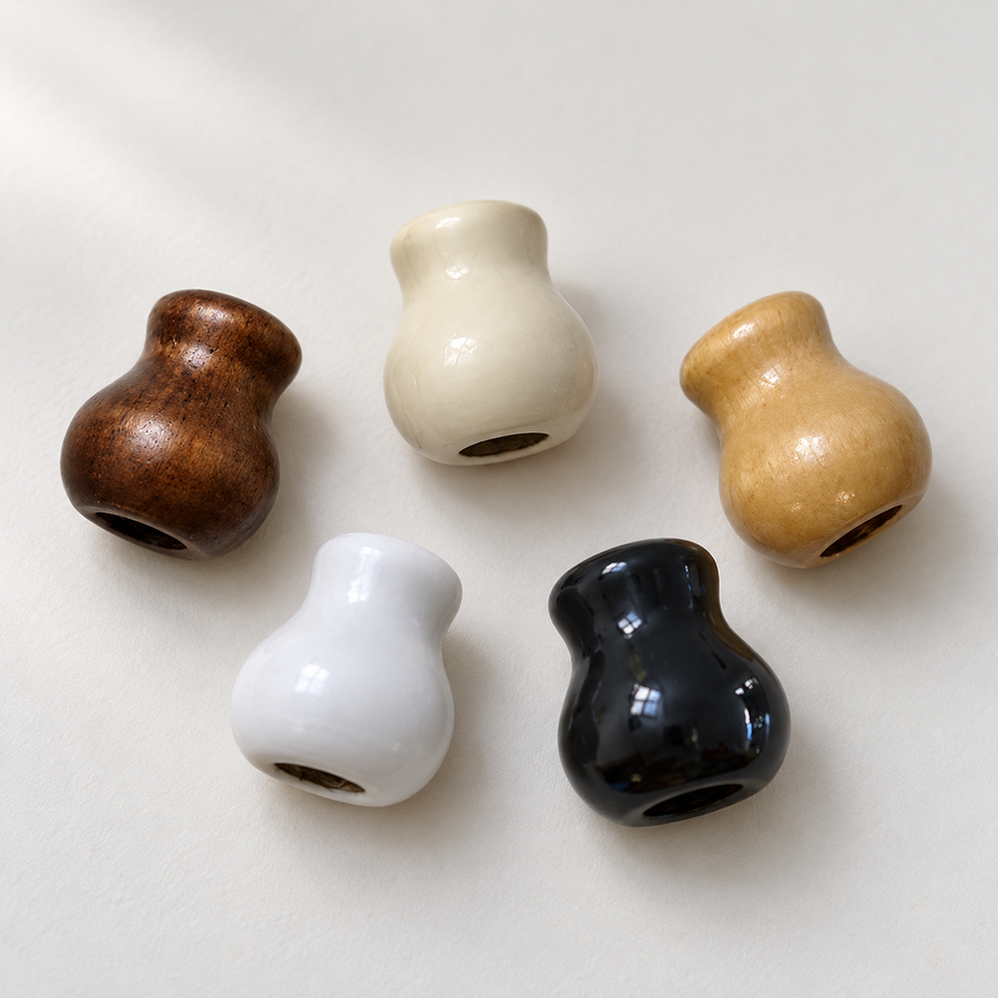 Bell-shaped wooden Roman blind cord pulls in white, ivory, black and wood finishes